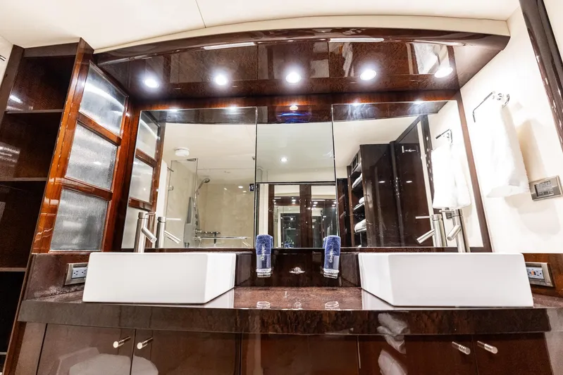 Liquid Asset Yacht Photos Pics Luxurious bathroom interior of 2010 Lazzara 78 Fly yacht with dual sinks and elegant wood finish.