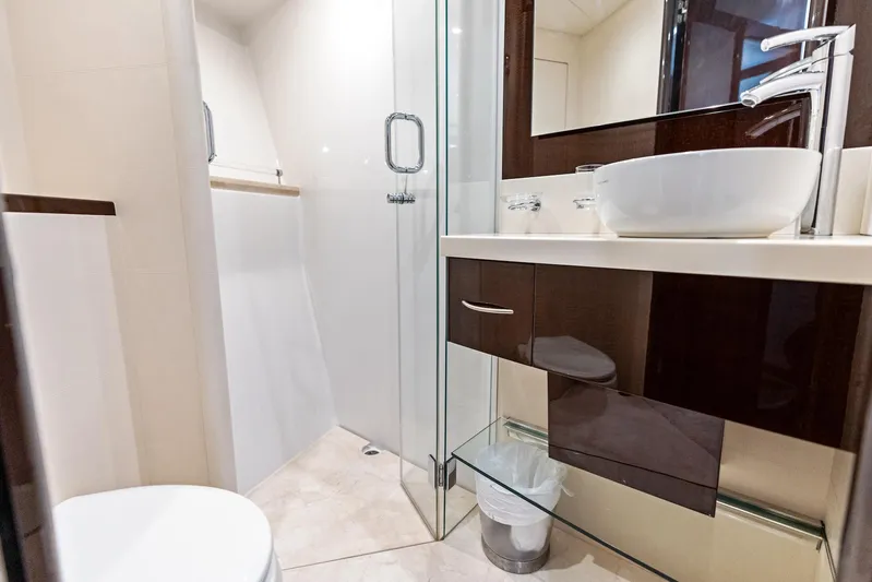 Liquid Asset Yacht Photos Pics Luxurious bathroom in 2010 Lazzara 78 Fly yacht with modern fixtures and glass shower.