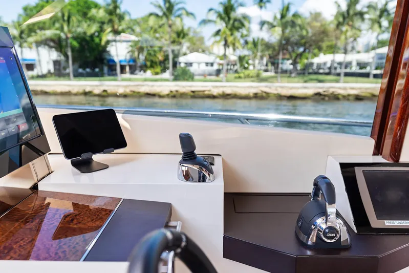 Liquid Asset Yacht Photos Pics Helm of 2010 Lazzara 78 Fly yacht with modern controls and scenic waterfront view.