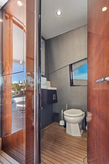 Liquid Asset Yacht Photos Pics Luxurious bathroom on 2010 Lazzara 78 Fly yacht with modern fixtures and wooden accents.