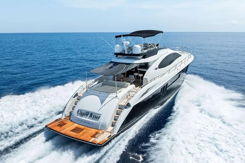 Liquid Asset Yacht Photos Pics Luxury 2010 Lazzara 78 Fly yacht cruising on open sea.
