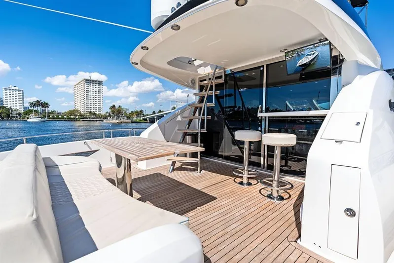 Liquid Asset Yacht Photos Pics Luxurious 2010 Lazzara 78 Fly yacht deck with seating, table, and waterfront view.