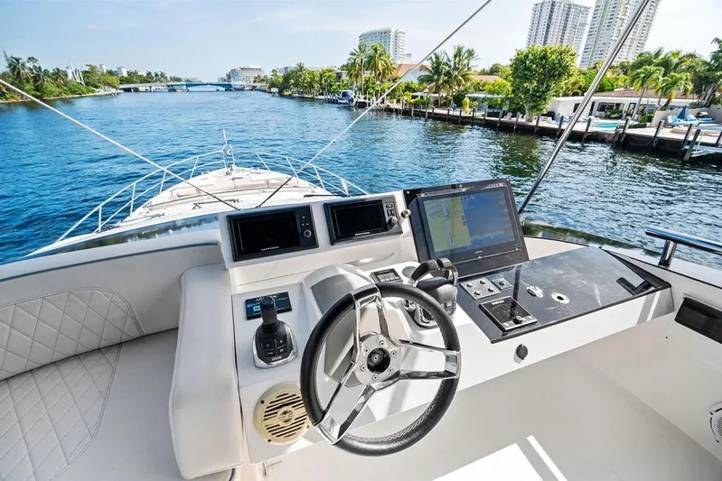 Liquid Asset Yacht Photos Pics Cockpit view of 2010 Lazzara 78 Fly yacht navigating a scenic waterway.