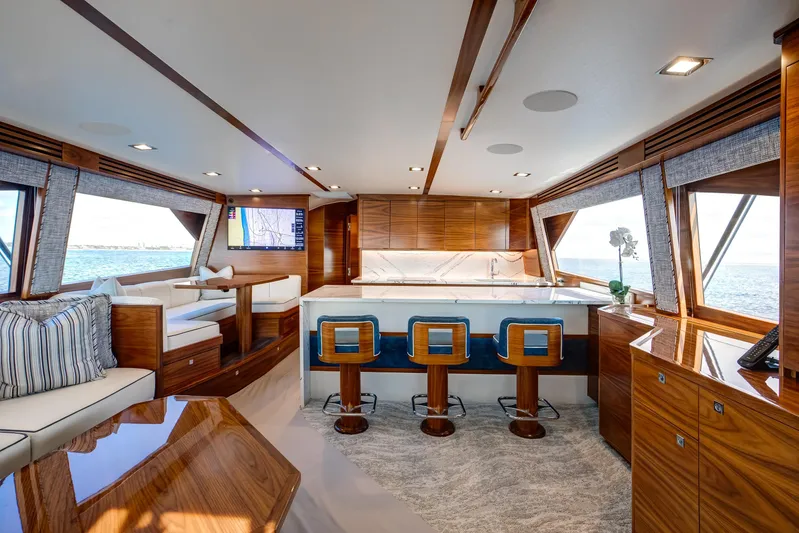 La Barca Yacht Photos Pics Luxurious interior of 2024 Viking 68 Convertible yacht with elegant wood finishes and ocean views.