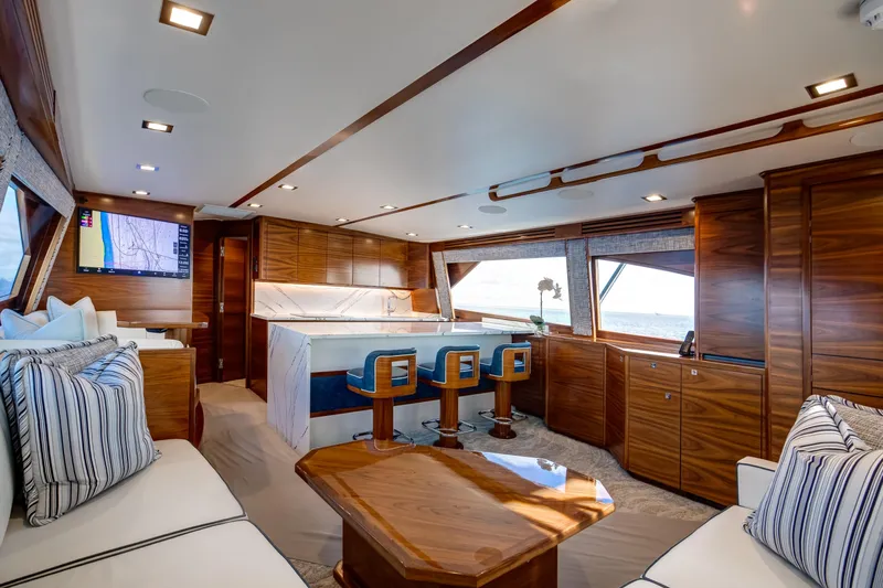 La Barca Yacht Photos Pics Luxurious interior of 2024 Viking 68 Convertible yacht with elegant wood finishes and modern seating.
