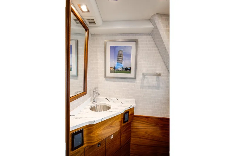 La Barca Yacht Photos Pics Luxurious bathroom in 2024 Viking 68 Convertible yacht with marble countertop and framed artwork.
