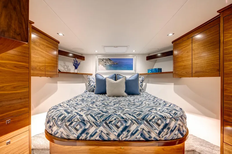 La Barca Yacht Photos Pics Luxurious 2024 Viking 68 Convertible yacht bedroom with elegant wood cabinetry and stylish bedding.