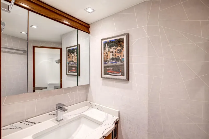 La Barca Yacht Photos Pics Luxurious bathroom interior of 2024 Viking 68 Convertible yacht with modern fixtures and artwork.