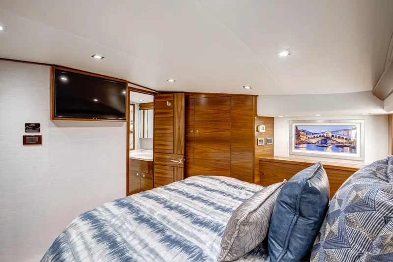 La Barca Yacht Photos Pics Luxurious 2024 Viking 68 Convertible yacht bedroom with modern decor and wood finishes.
