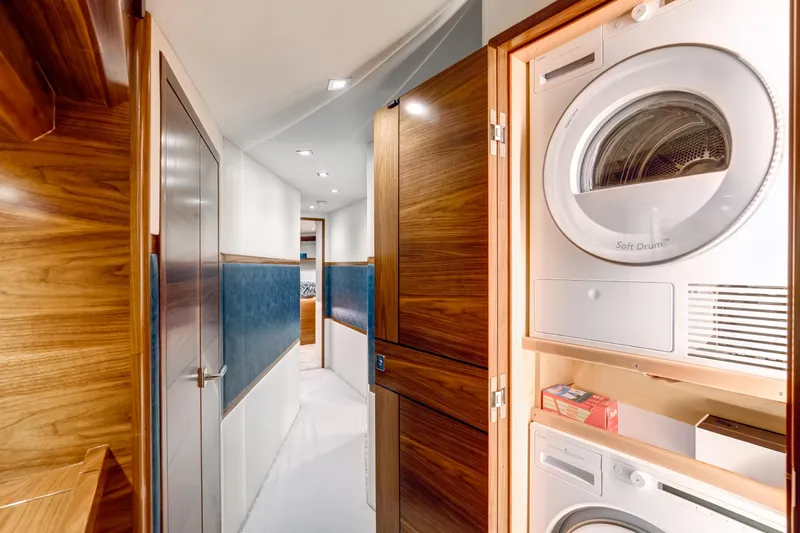 La Barca Yacht Photos Pics 2024 Viking 68 Convertible yacht interior with laundry appliances in hallway.