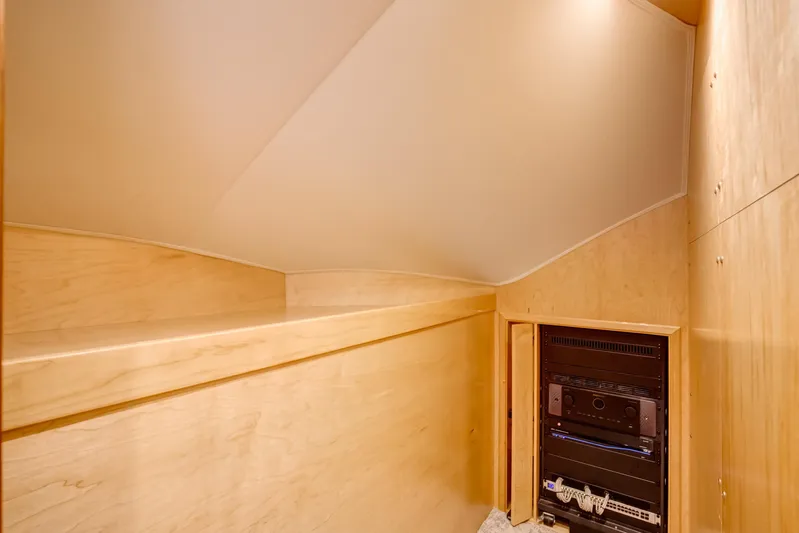 La Barca Yacht Photos Pics 2024 Viking 68 Convertible yacht interior with wooden cabinetry and electronic equipment.