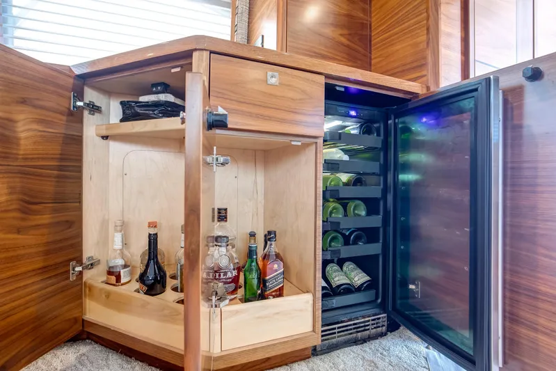 La Barca Yacht Photos Pics Luxurious 2024 Viking 68 Convertible yacht bar with wine cooler and liquor cabinet.