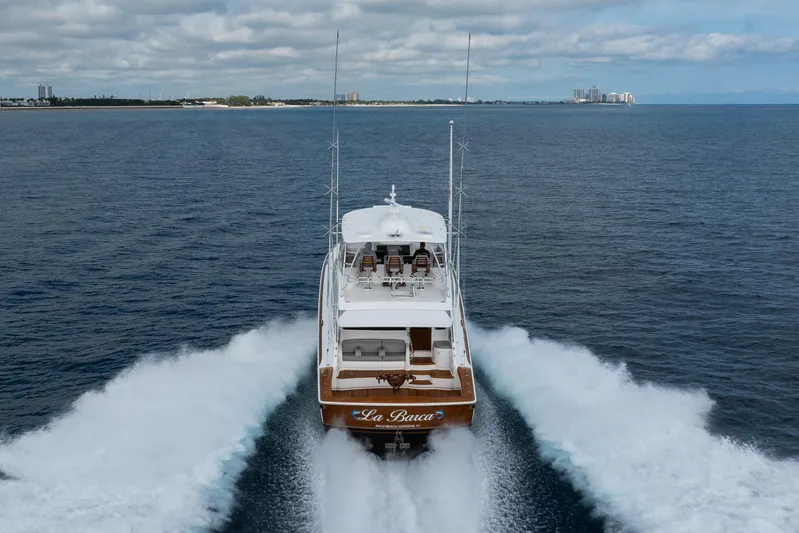 La Barca Yacht Photos Pics 2024 Viking 68 Convertible yacht cruising on open sea, leaving a wake behind.