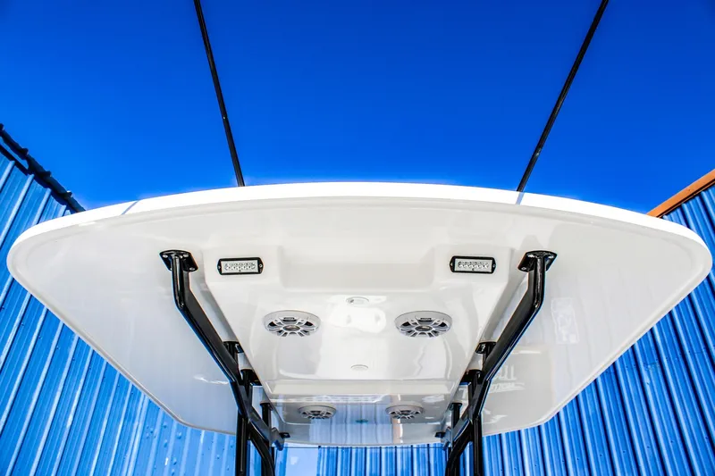  Yacht Photos Pics 2026 Invicta 320 CC boat canopy with speakers and lights against blue sky.