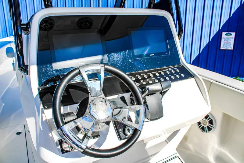  Yacht Photos Pics Steering console of 2026 Invicta 320 CC boat with dual screens and controls.