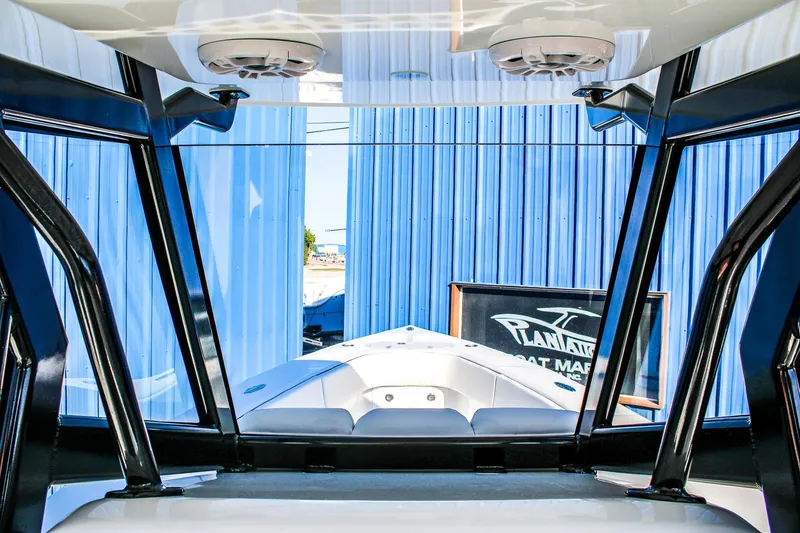  Yacht Photos Pics Interior view of 2026 Invicta 320 CC boat with blue exterior background.