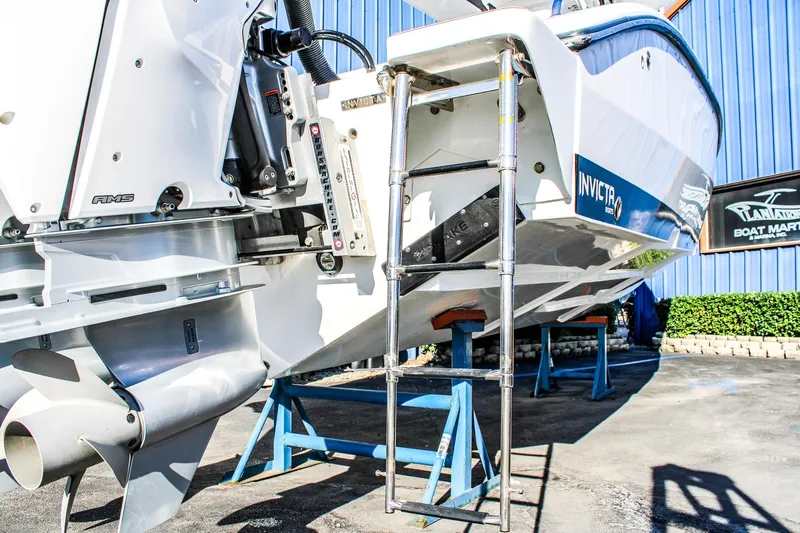  Yacht Photos Pics 2026 Invicta 320 CC boat on stands, showcasing rear view and motor details.
