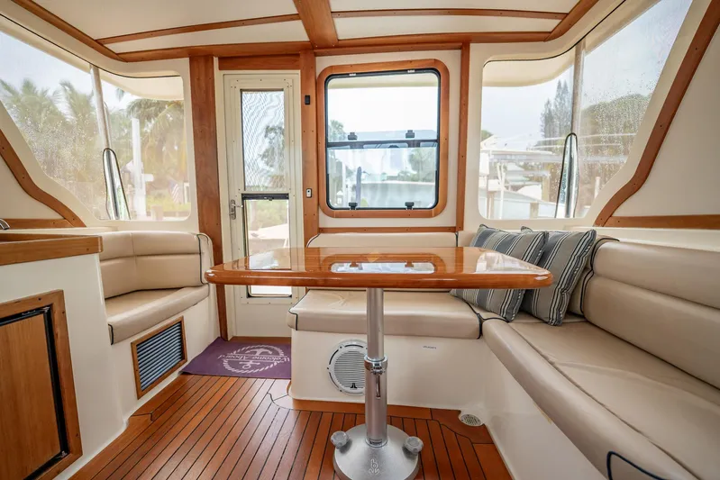 Moondance Yacht Photos Pics Luxurious interior of 2006 Sabre 42 Express yacht with elegant seating and wooden table.