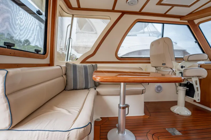 Moondance Yacht Photos Pics Interior of 2006 Sabre 42 Express yacht with plush seating and wooden table.