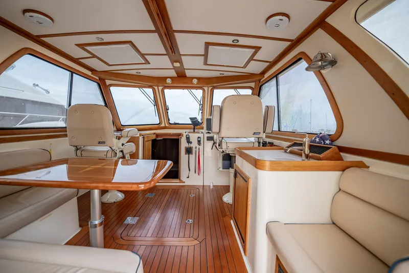 Moondance Yacht Photos Pics Interior of 2006 Sabre 42 Express yacht with wood accents and seating area.