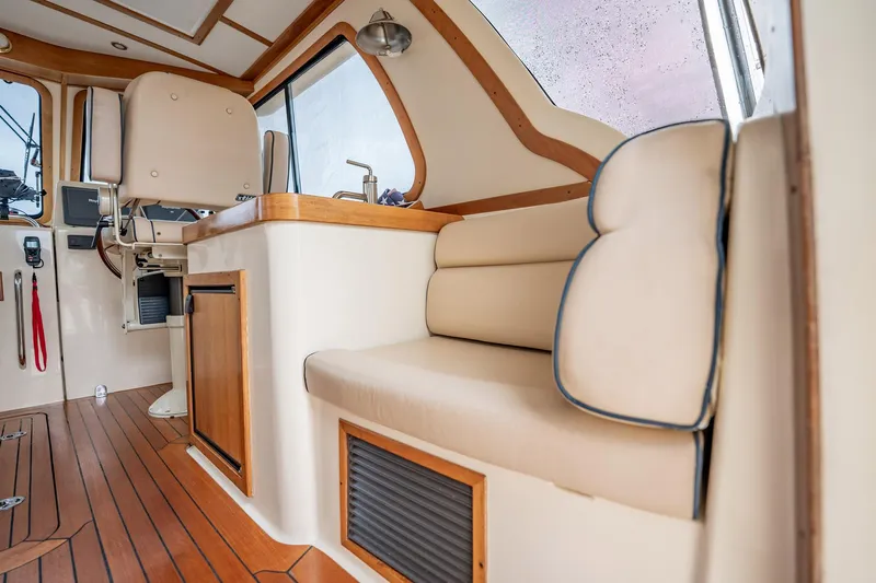 Moondance Yacht Photos Pics Interior of 2006 Sabre 42 Express yacht with beige seating and wooden accents.