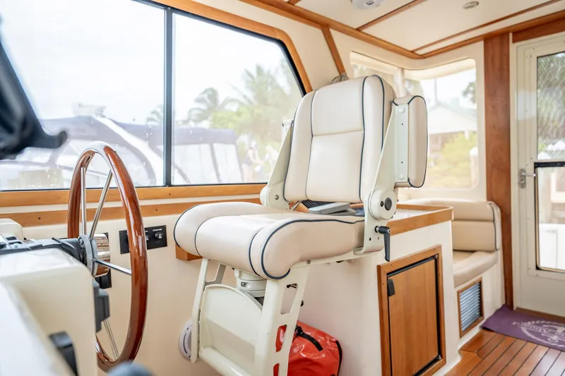 Moondance Yacht Photos Pics Interior of 2006 Sabre 42 Express yacht with captain's chair and wooden accents.