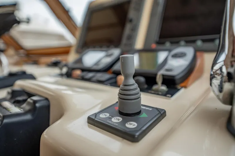 Moondance Yacht Photos Pics Control panel of a 2006 Sabre 42 Express yacht with joystick and navigation screens.