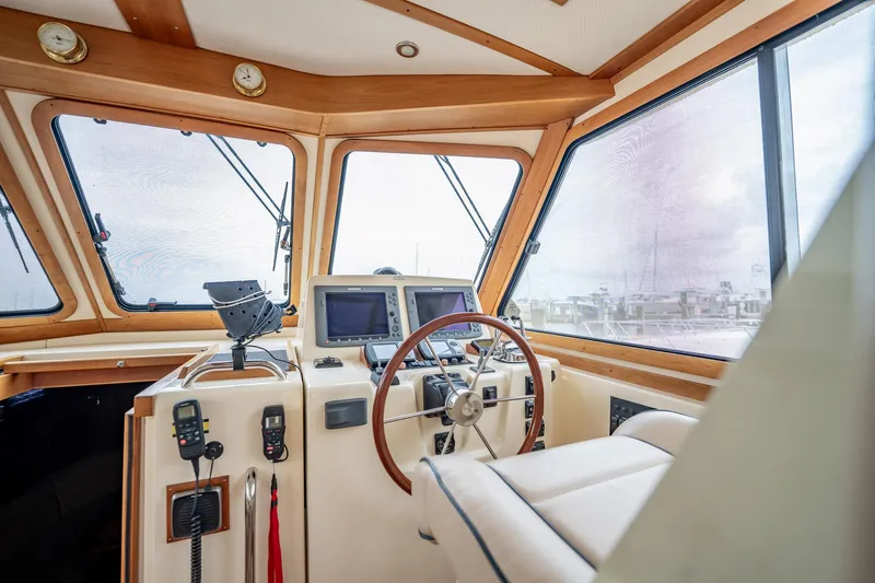 Moondance Yacht Photos Pics Helm of 2006 Sabre 42 Express yacht with navigation equipment and wooden accents.