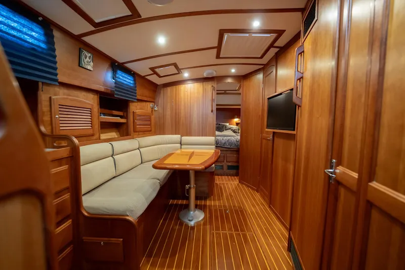 Moondance Yacht Photos Pics Luxurious interior of 2006 Sabre 42 Express yacht with wood finish and cozy seating area.