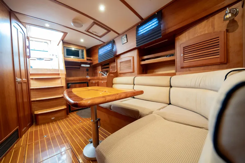 Moondance Yacht Photos Pics Luxurious interior of 2006 Sabre 42 Express yacht with wooden finishes and cozy seating.