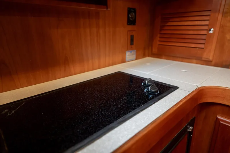 Moondance Yacht Photos Pics 2006 Sabre 42 Express yacht kitchen with sleek countertop and stove.