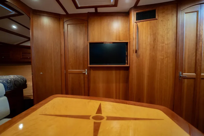 Moondance Yacht Photos Pics Luxurious wood interior of 2006 Sabre 42 Express yacht with TV and decorative table.