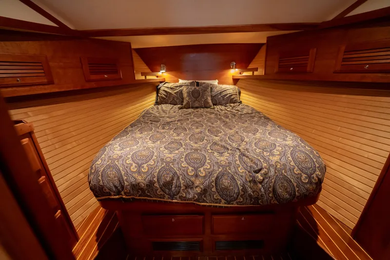 Moondance Yacht Photos Pics Luxurious cabin interior of 2006 Sabre 42 Express yacht with elegant bedding and wood paneling.