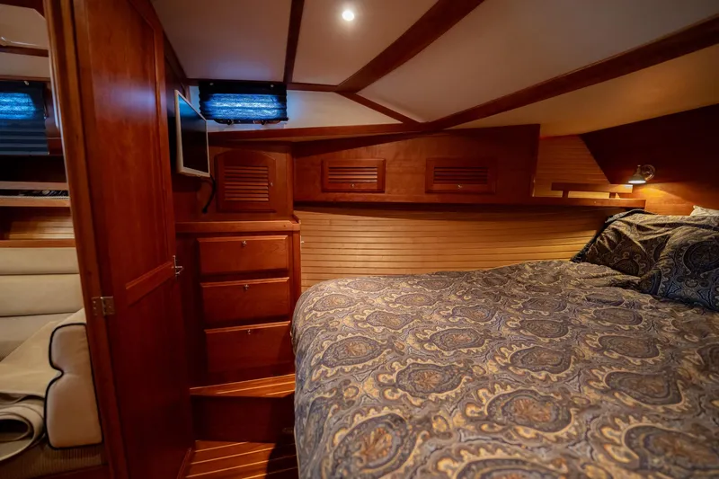 Moondance Yacht Photos Pics Luxurious cabin interior of 2006 Sabre 42 Express yacht with wood finish and cozy bedding.