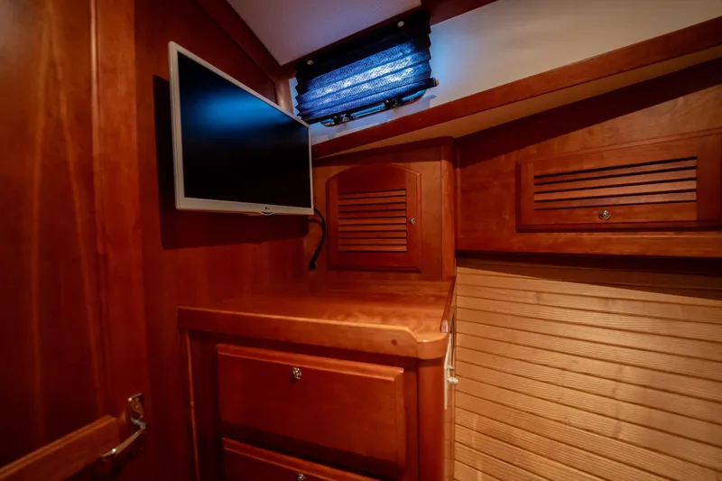 Moondance Yacht Photos Pics 2006 Sabre 42 Express interior with wood cabinetry and mounted TV.