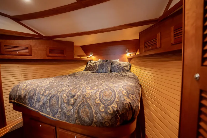 Moondance Yacht Photos Pics Luxurious cabin interior of 2006 Sabre 42 Express yacht with cozy bed and wooden accents.