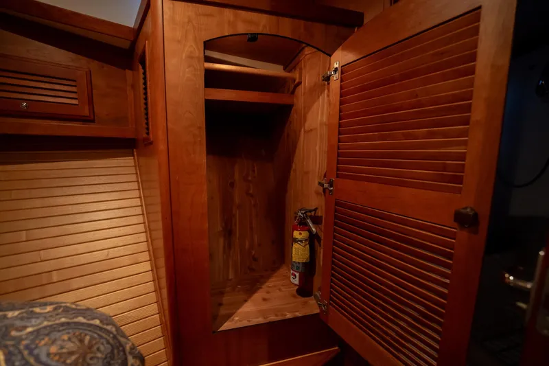 Moondance Yacht Photos Pics Wooden closet interior with fire extinguisher on a 2006 Sabre 42 Express boat.