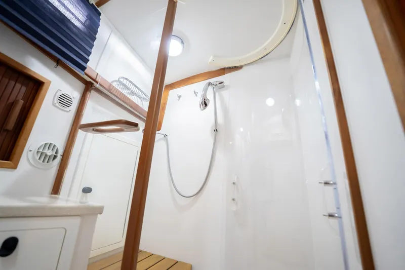 Moondance Yacht Photos Pics Bathroom interior of 2006 Sabre 42 Express yacht with shower and wooden accents.