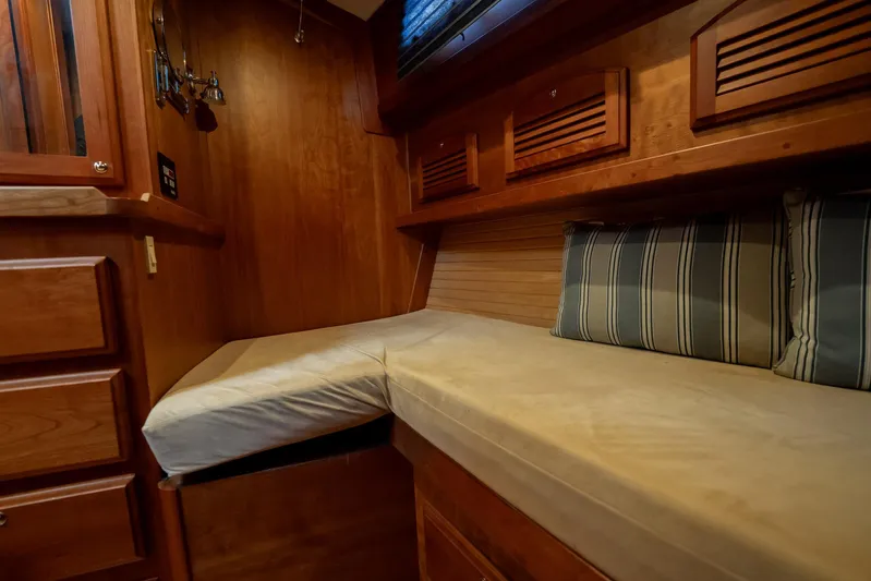 Moondance Yacht Photos Pics 2006 Sabre 42 Express cabin interior with wooden finish and striped cushions.