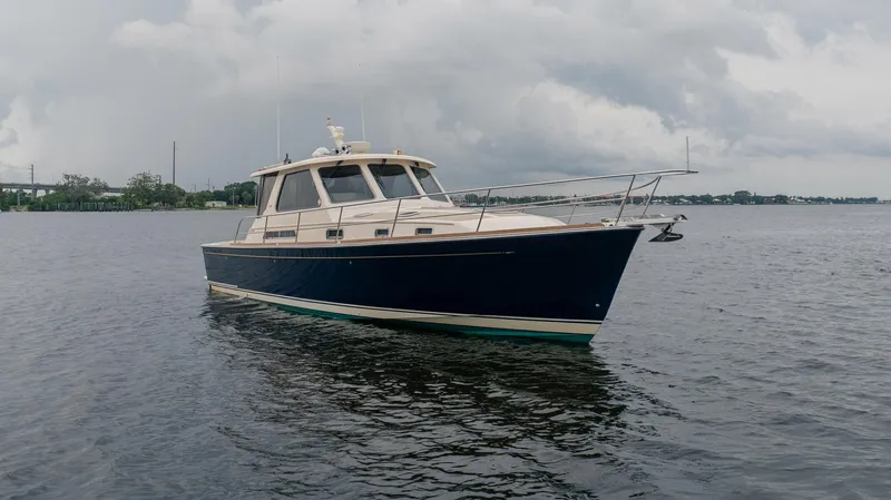 Moondance Yacht Photos Pics 2006 Sabre 42 Express yacht on calm waters under cloudy skies.