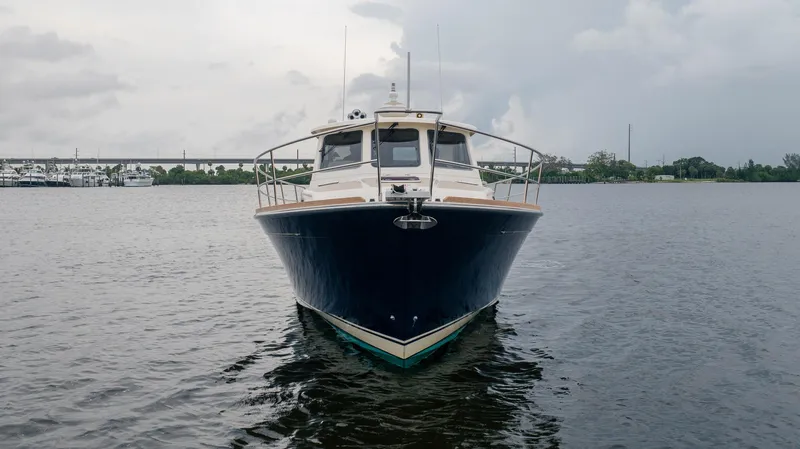 Moondance Yacht Photos Pics 2006 Sabre 42 Express yacht on calm water under cloudy sky.