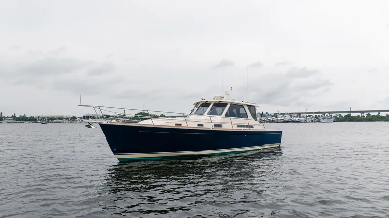 Moondance Yacht Photos Pics 2006 Sabre 42 Express yacht on calm water under cloudy sky.