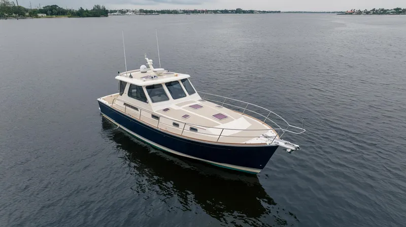 Moondance Yacht Photos Pics 2006 Sabre 42 Express yacht on calm water, showcasing sleek design and elegance.