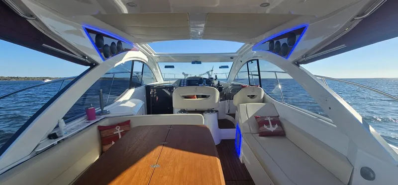 Mambo Italiano Yacht Photos Pics Interior view of 2015 Beneteau 38 Gran Tourismo yacht with modern seating and ocean backdrop.