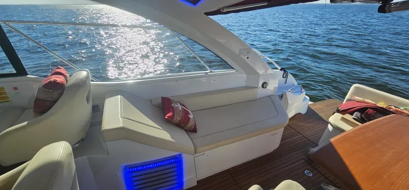 Mambo Italiano Yacht Photos Pics 2015 Beneteau 38 Gran Tourismo yacht interior with seating, cushions, and ocean view.