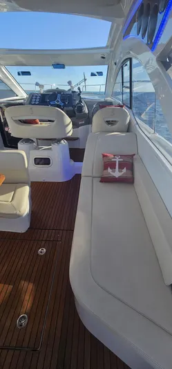 Mambo Italiano Yacht Photos Pics Interior of 2015 Beneteau 38 Gran Tourismo yacht with elegant seating and wooden flooring.