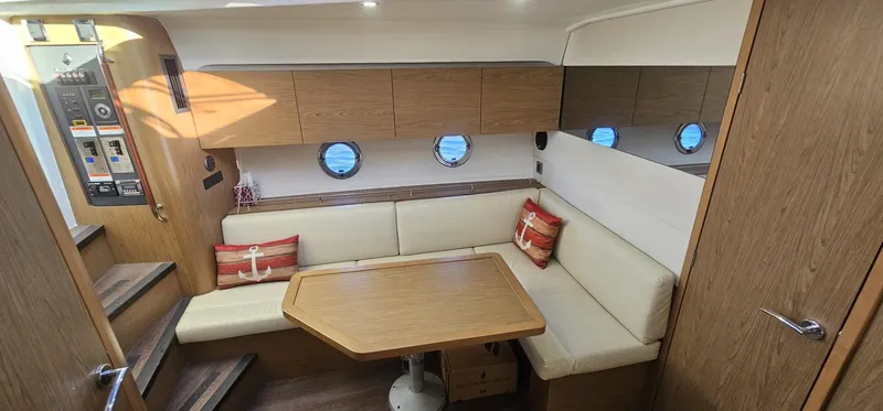 Mambo Italiano Yacht Photos Pics Interior of 2015 Beneteau 38 Gran Tourismo yacht with cozy seating and wooden accents.