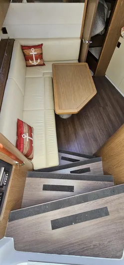 Mambo Italiano Yacht Photos Pics Interior of 2015 Beneteau 38 Gran Tourismo with cozy seating and wooden table.