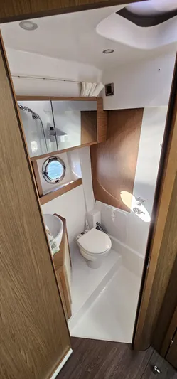 Mambo Italiano Yacht Photos Pics 2015 Beneteau 38 Gran Tourismo bathroom with modern fixtures and wooden accents.