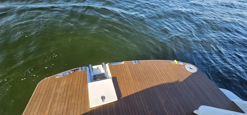 Mambo Italiano Yacht Photos Pics 2015 Beneteau 38 Gran Tourismo swim platform with teak decking on calm water.